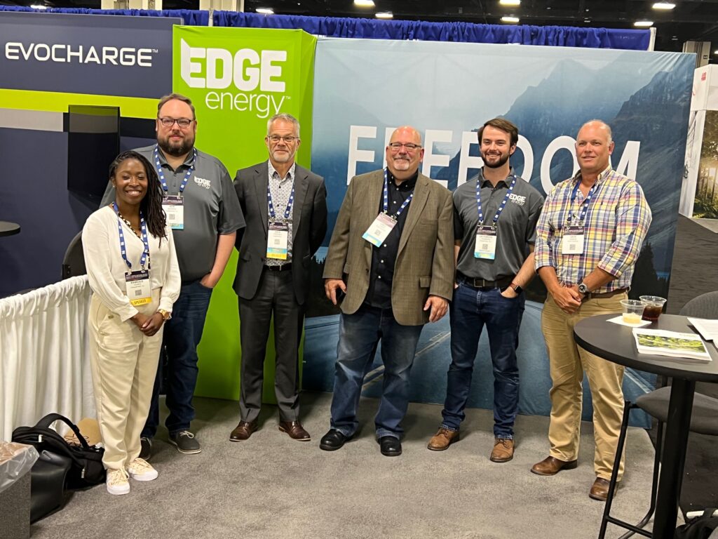 Group of people posing at the EdgeEnergy tent at an industry event