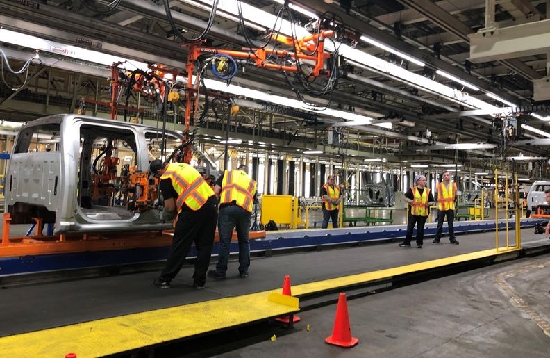 Autoworkers on an assembly line
