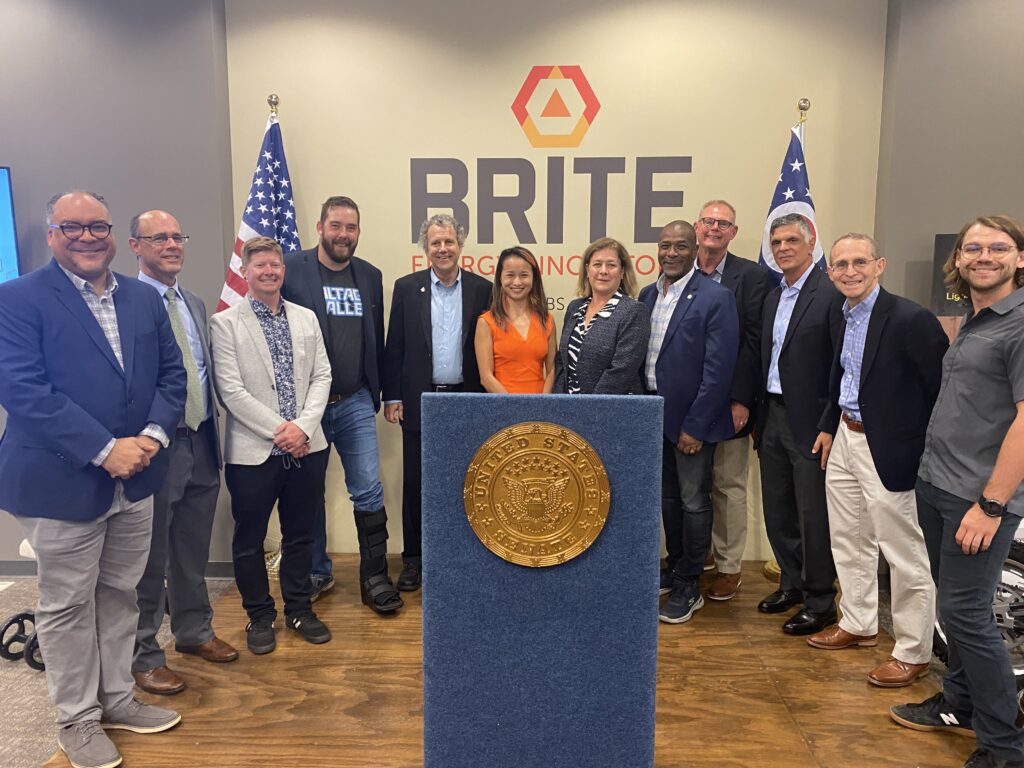 Senator Sherrod Brown and guests post in front of BRITE sign at BRITE headquarters