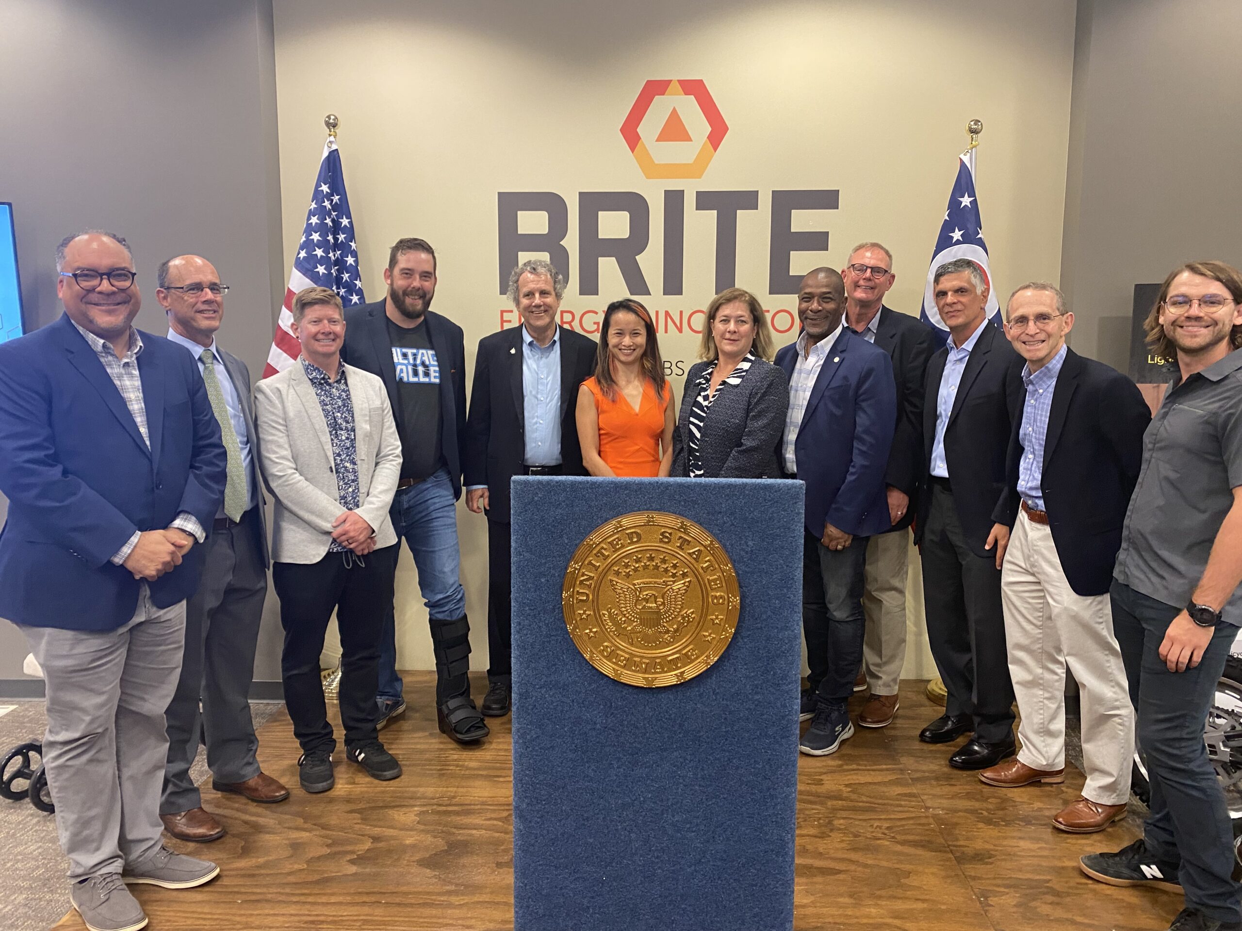 Senator Sherrod Brown and guests post in front of BRITE sign at BRITE headquarters