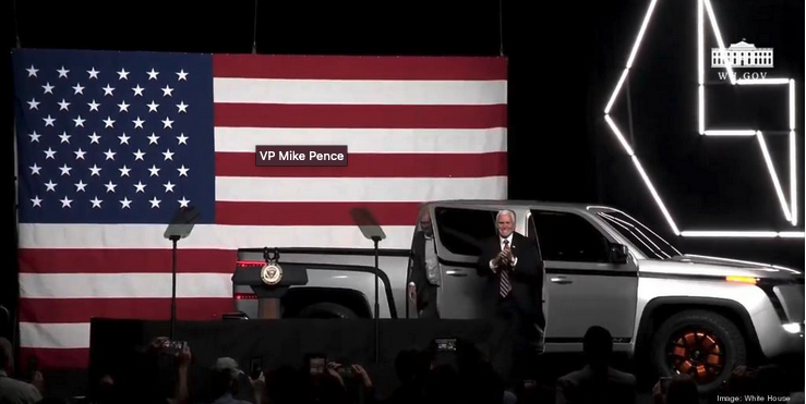 Mike Pence near an electric truck at an event