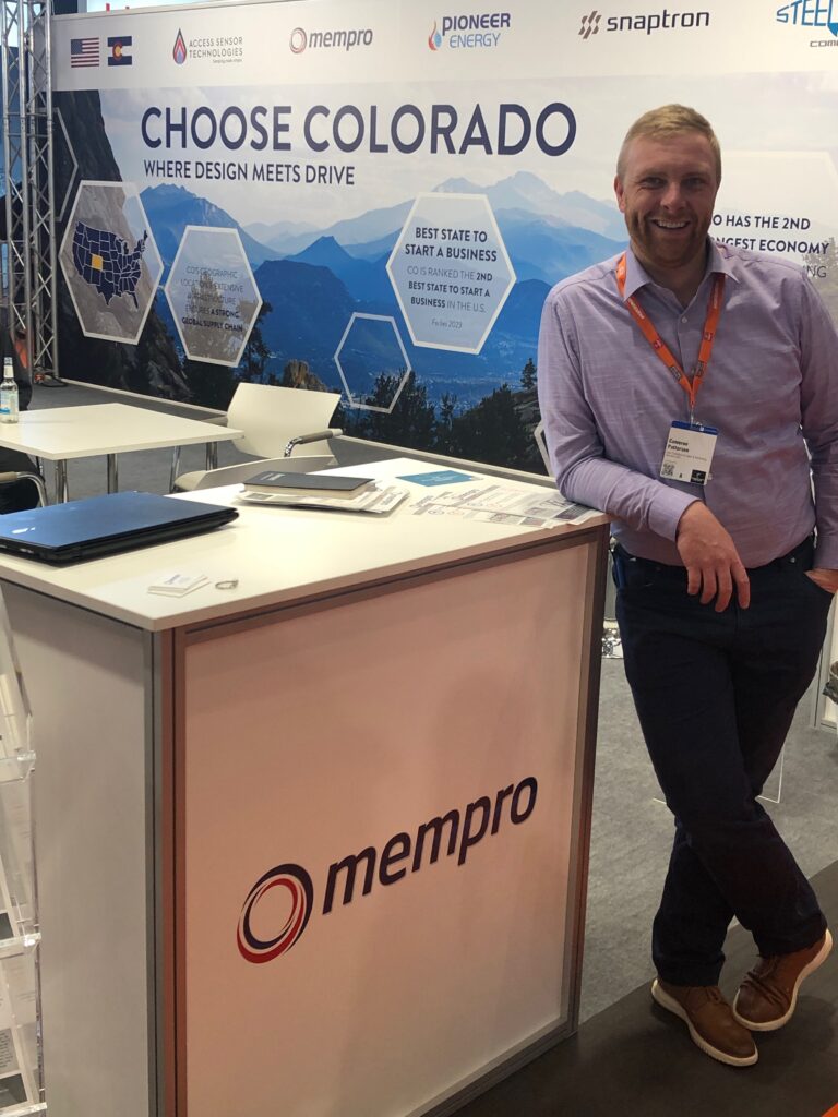BRITE startup ember Mempro posing at their booth at an industry event