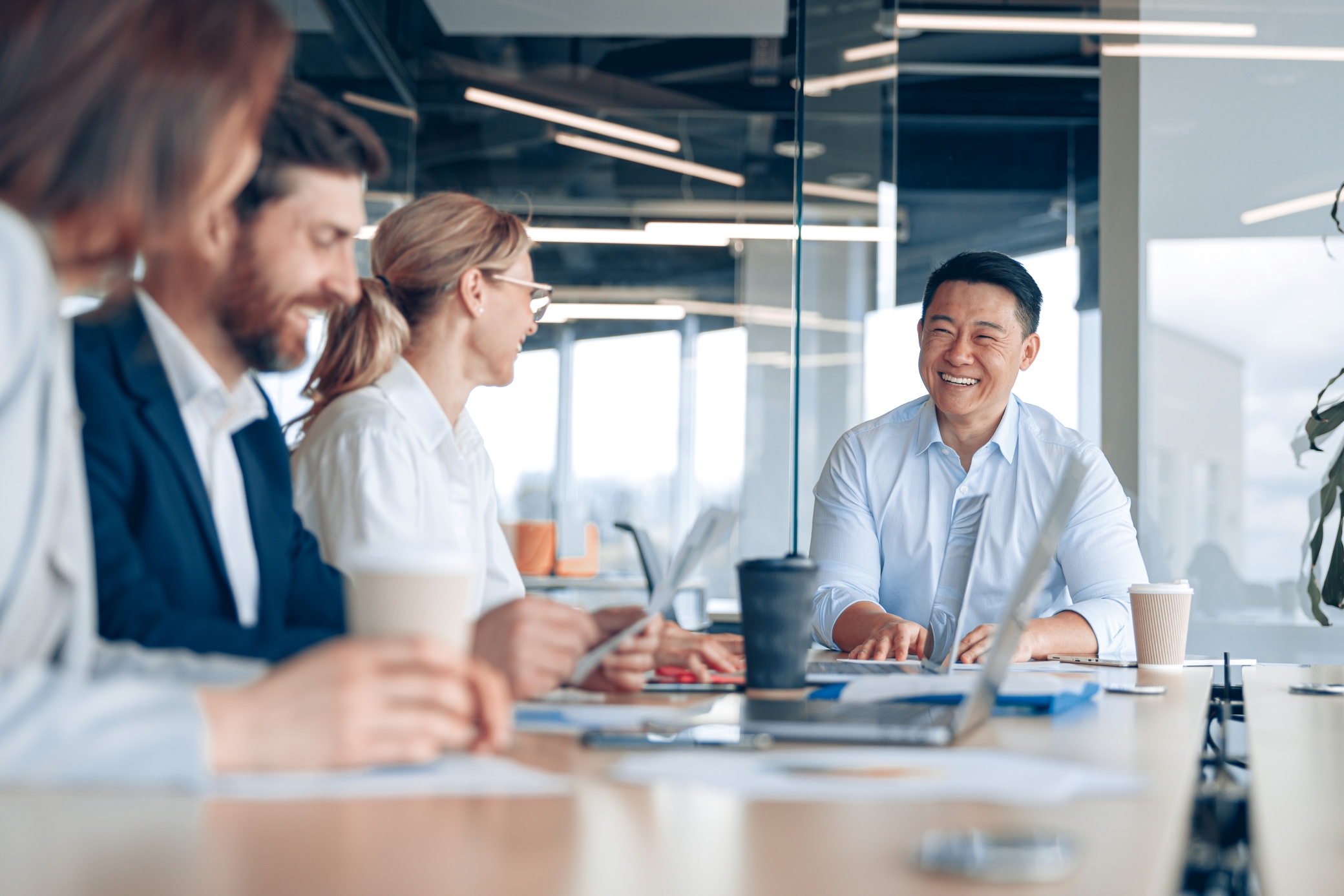 Four professionals working at a conference table together