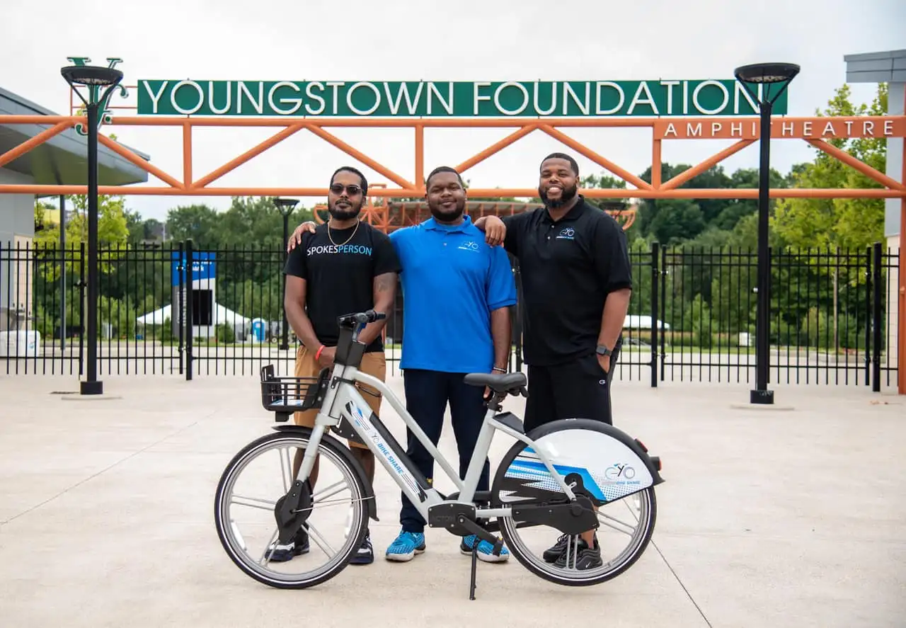YoGo Bikeshare team poses in front of their electric bike