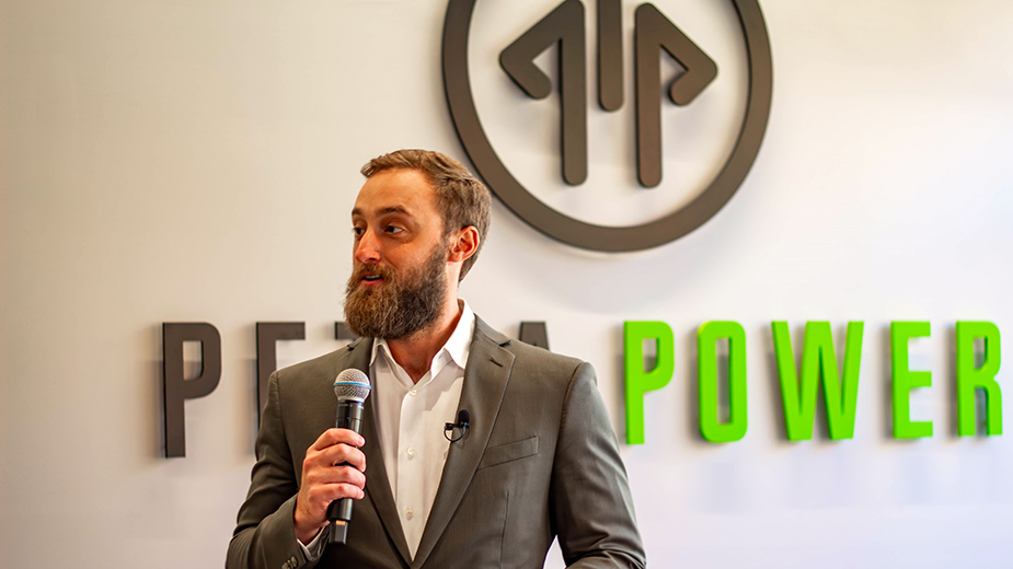 Aaron Goodman of Petra Power speaking into a microphone at their new headquarters.